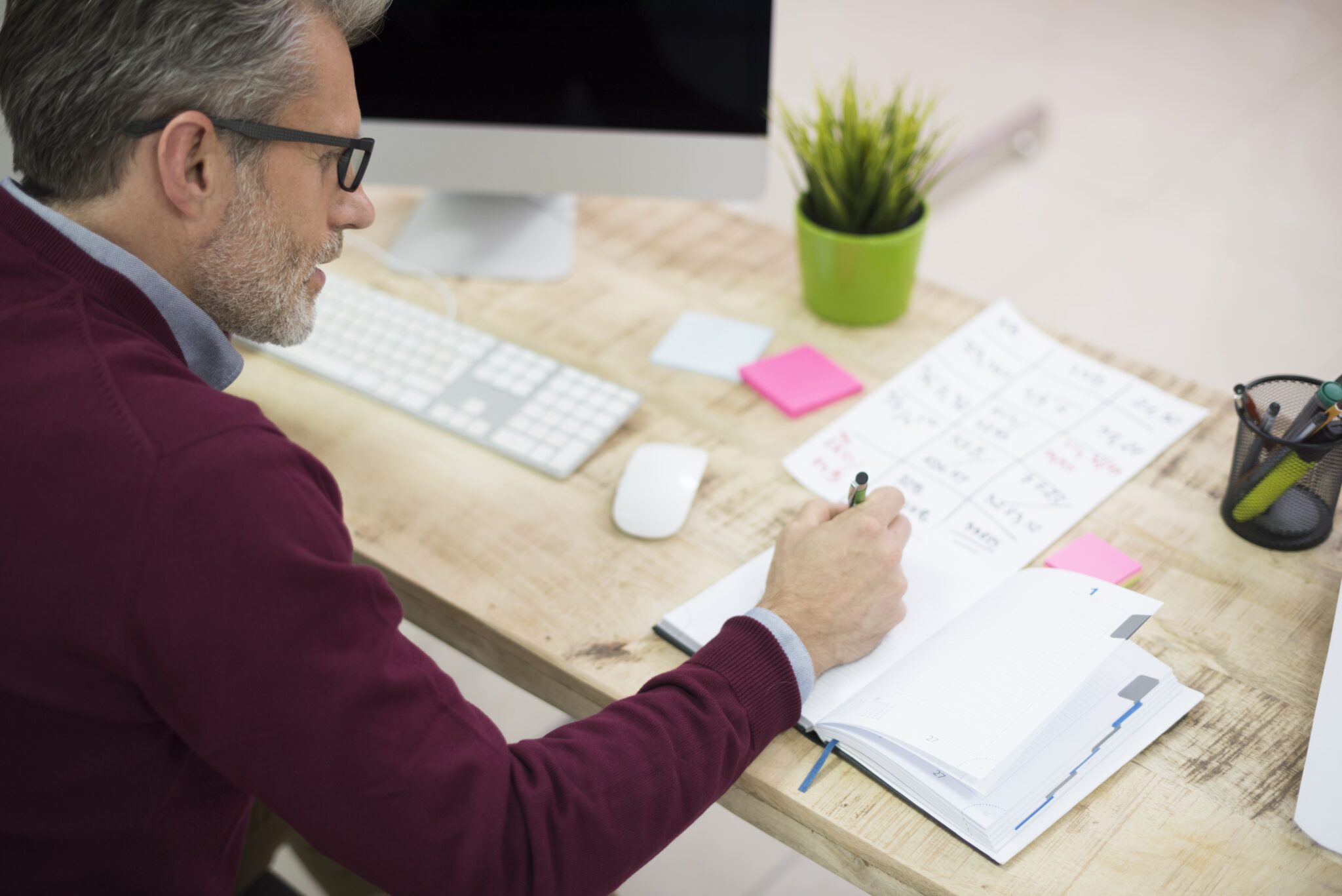 An owner working through preparation notes at a desk