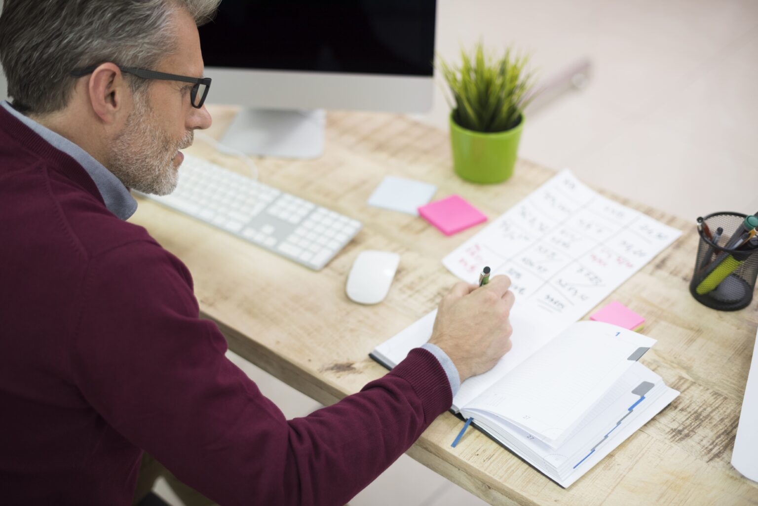 Advisor working through financial notes at a desk